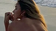Fans 'jealous of ocean' as volleyball star Kayla Simmons goes topless on beach