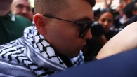 Kneecap star in court after 'Hezbollah flag’ terror charge surrounded by mob