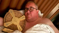 Topless Bunting copies Littler as he sleeps with Nordic Darts Masters Trophy