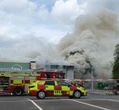 Massive fire breaks out at retail park in town centre sending smoke into sky