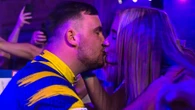 Littler plants kiss on girlfriend Faith, 19, during World Matchplay walk-on