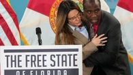 Moment doctor leaps onto stage to save politician as she faints mid-speech