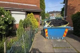 Huge skip has been to rot on my driveway for WEEKS & bungling firm won't take it