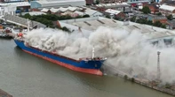 Blaze tears through huge container ship at UK dock sending smoke billowing