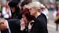Ozzy's daughter Kelly hugs family as fans say goodbye to rock legend