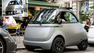 Inside minuscule bubble car with open top roof that opens like a Rolls Royce