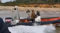 Moment drug-smuggling pals DIVE into water during boat chase to flee cops
