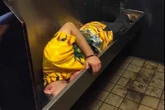 Darts star, 44, keeps getting tagged in picture of man asleep in urinal