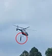 Moment man clings to helicopter as it takes off after ‘begging for a ride’