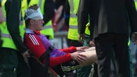 Shock moment Aberdeen ace treated after being hit by seat thrown from own fans