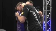 Darts star hugs rival after win days after family bereavement