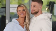 Kerry Katona's new man revealed as a hunky trainer as they snog on the street
