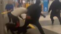 Moment travelers smack each other with wet floor signs in airport brawl