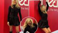 Ashley Roberts risks flashing fans as she rolls around in tiny mini-skirt