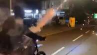 Moment yobs strap fireworks to bike and race down street launching rockets