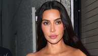 Kim Kardashian flashes her abs in a tube top as she climbs into $100k Cybertruck