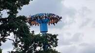 Moment 28 thrillseekers are left dangling 100ft in the air after ride stalls