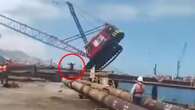 Moment crane collapses as its driver narrowly avoids being crushed to death