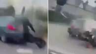 Moment motorcyclist is sent hurtling through the air after crashing into car