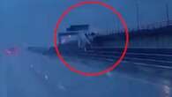 Dramatic moment lorry crashes through bridge barrier & plunges 60ft