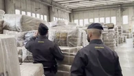 Maxi sequestro di falsi Armani: oltre 65mila tute e felpe contraffatte in un deposito a Lacchiarella