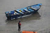 Eight migrants found alive after boat capsizes, 10-year-old missing