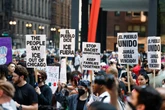 Woman charged after she drove through anti-ICE protesters, police say