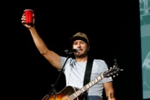 Luke Bryan reacts after being hit in the face by object during concert