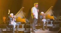 Morgan, le accuse di stalking non fermano il concerto a Desio. È bufera: «Sul palco con la figlia a fare scudo» – Il video
