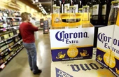 Corona's owner says beer sales have slowed because one major customer group isn't buying beer like it used to