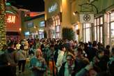 Photos show Black Friday crowds at retailers across the US even as more shoppers move online