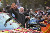 Indian PM Modi steals limelight at lavish Ambani wedding as route to the ceremony lined with posters