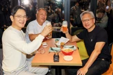 A detail in this photo of Jensen Huang having fried chicken with the heads of Samsung and Hyundai shows the extent of his tech celebrity