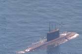 A NATO sub hunter captured these shots of a Russian submarine in waters newly surrounded by the alliance