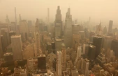 Canadian wildfires are shrouding US cities in smoke and yellow haze. See the eerie photos.