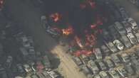 Several hundred crushed cars burn in a massive junkyard fire near L.A.