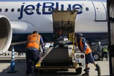 JetBlue joins other airlines and raises checked luggage fees