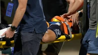Aussie superstar stretchered off with suspected spinal injury