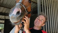 Much-loved jockey found under dead horse and rushed to hospital