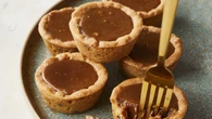 Kirsten Tibballs shares her decadent caramel peanut cookie cups and sticky date pudding recipes