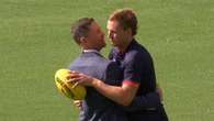 Grieving AFL champions share powerful embrace after family tragedies