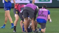 West Coast captain helped from the field in hand of medical staff