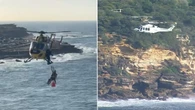 Warning as two swimmers winched from rocks at popular beach