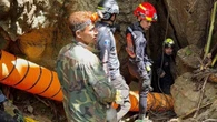 Rescuers race to reach seven trapped in flooded Laos cave