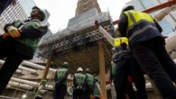 Medieval church lifted on stilts during skyscraper construction