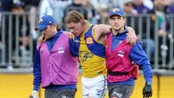 Harley Reid limps off the field in the hands of trainers