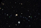 Weird line of galaxies may have been created by a cosmic bullet