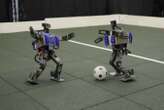 Watch mini humanoid robots showing off their football skills