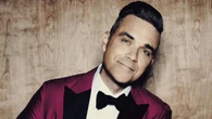 Robbie Williams desata la risa (y el desconcierto) de Julia Roberts con una confesión surrealista