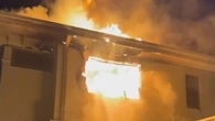 Woman charged over fire that critically injured two young girls